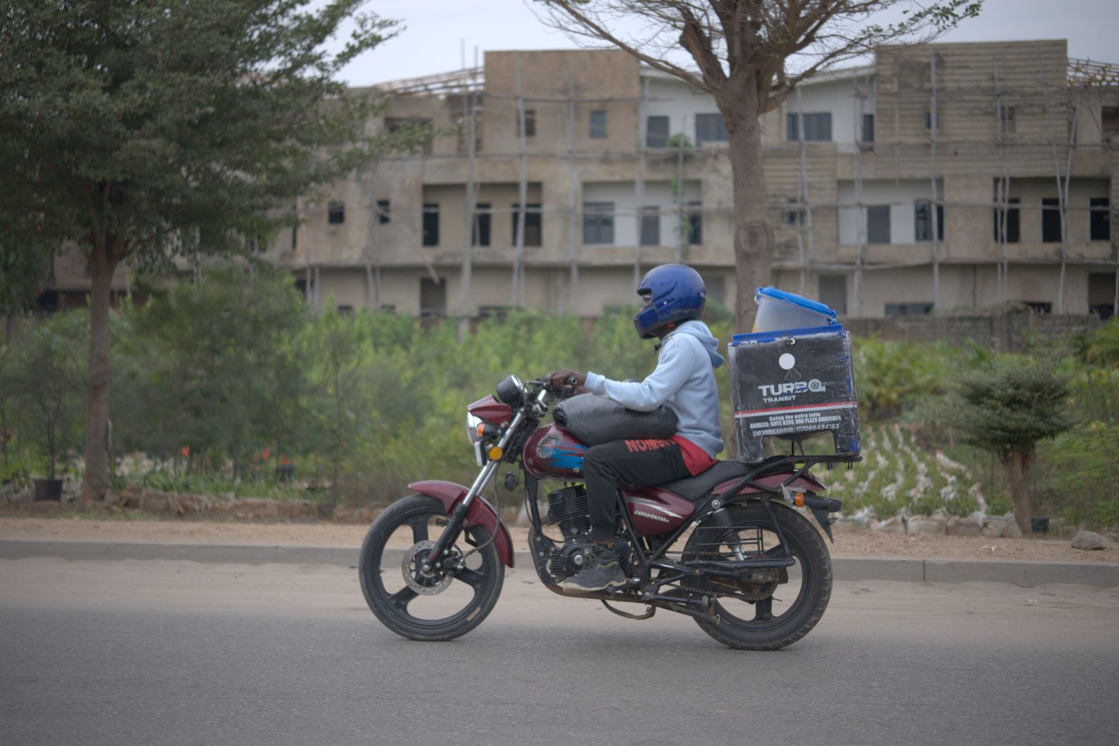 Delivery rider on a motorbike with a cargo box